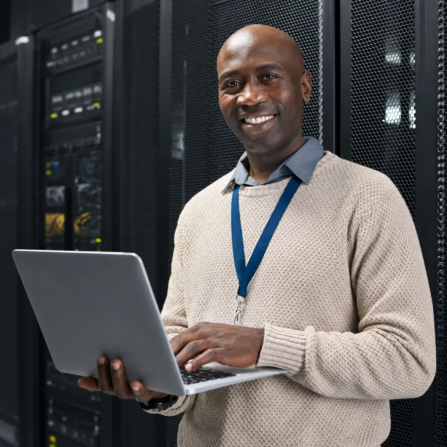 Network engineer with a laptop in a server room