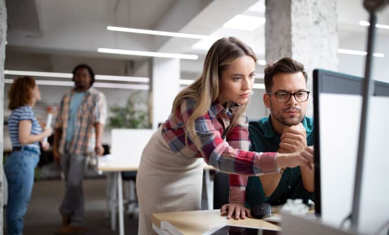 Team of IT support specialists working together to solve a problem