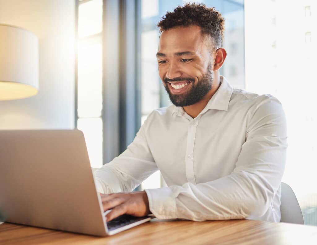 Happy manager using Microsoft 365 for small business on computer