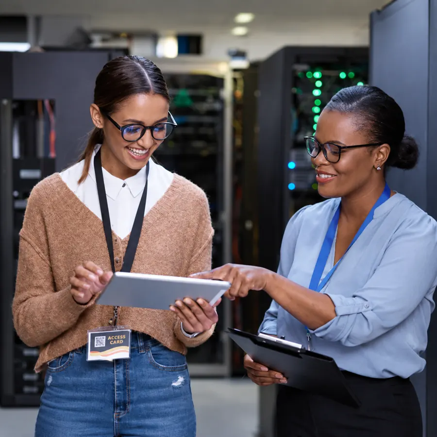 Two AIS engineers reviewing a tablet in a server room